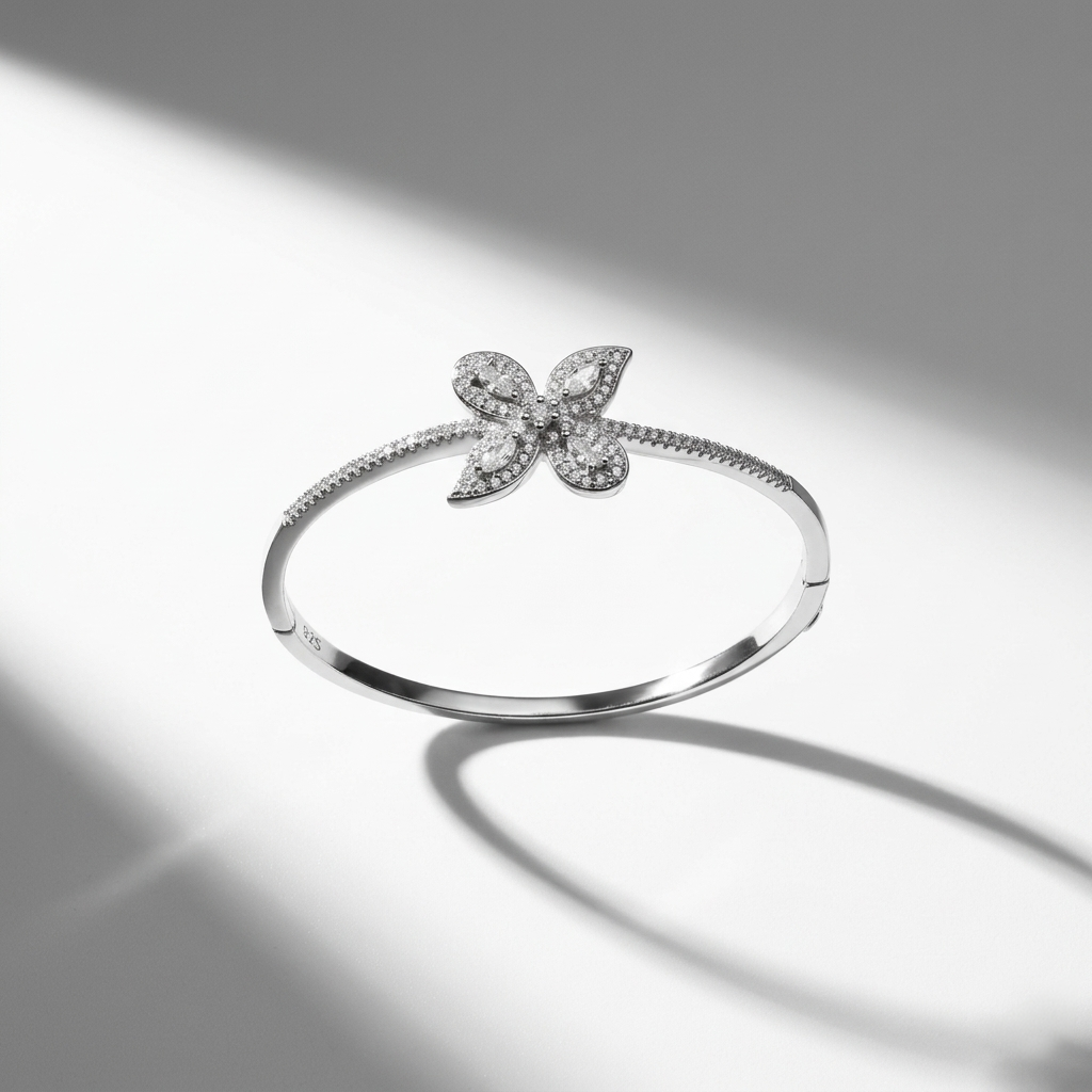 925 sterling silver butterfly kada with hinged lock resting on a bright white surface