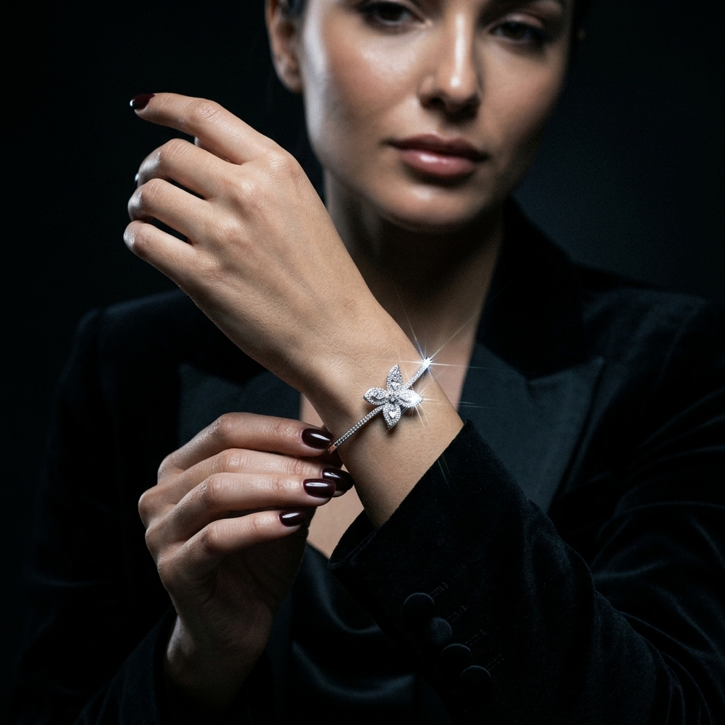 Close-up of a woman in a black velvet blazer adjusting a radiant silver butterfly kada with cubic zirconia crystals
