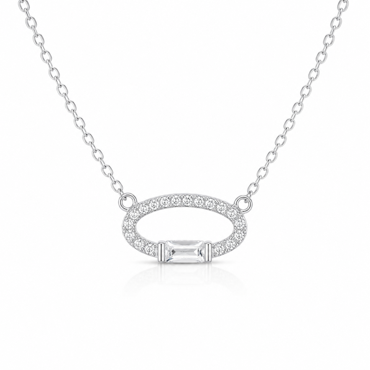 Woman wearing a delicate silver chain necklace with a crystal-encrusted open oval pendant.