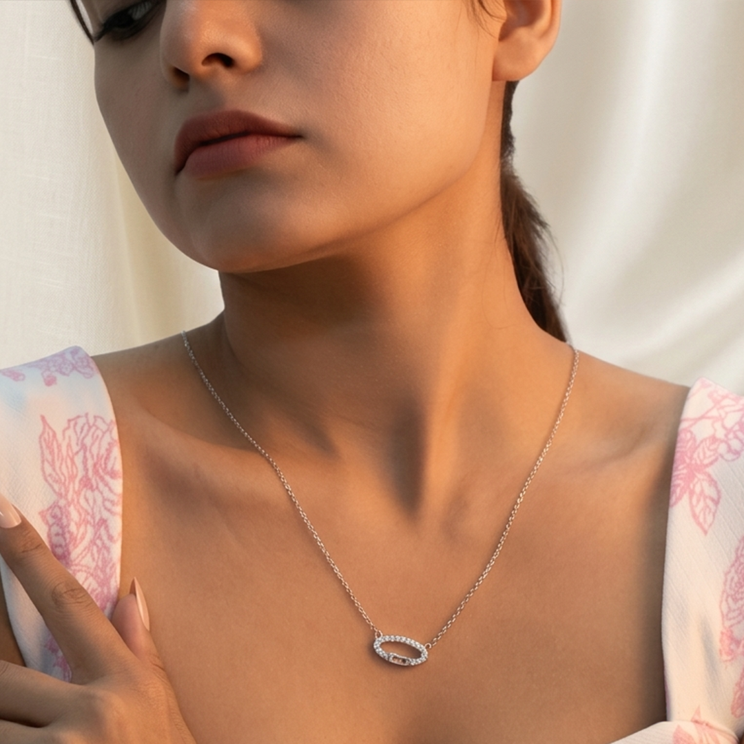 Detailed view of the fine silver cable chain and sparkling oval pendant.