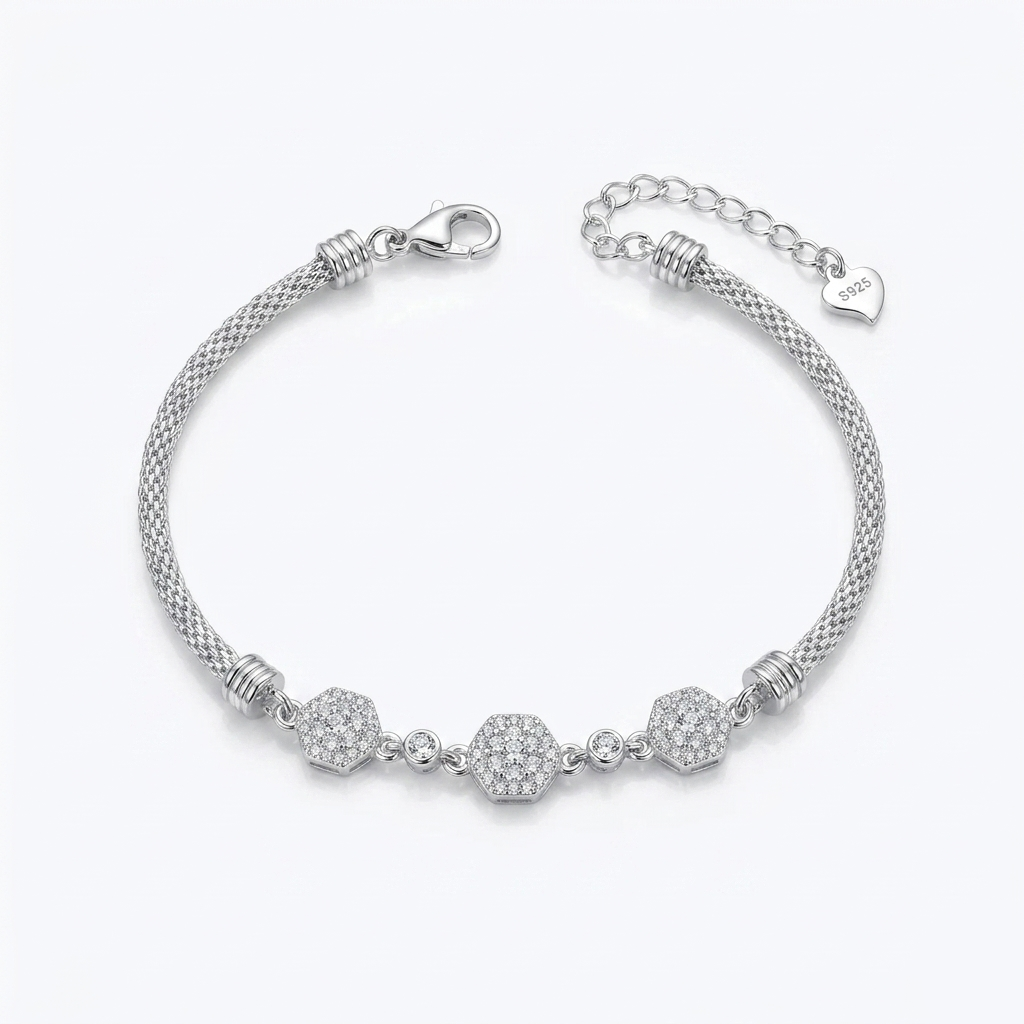 Flat lay of a Diamond Whisper Silver Bracelet featuring three paved hexagon charms and a lobster clasp against a white background