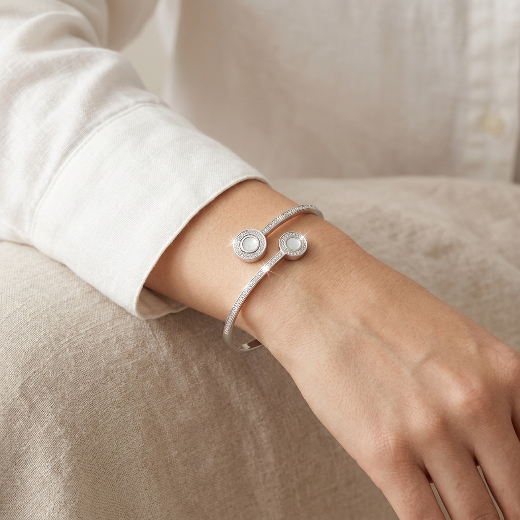 Woman wearing a Dual Circle Silver Open Kada with two moonstone circle motifs and crystal accents on her wrist.
