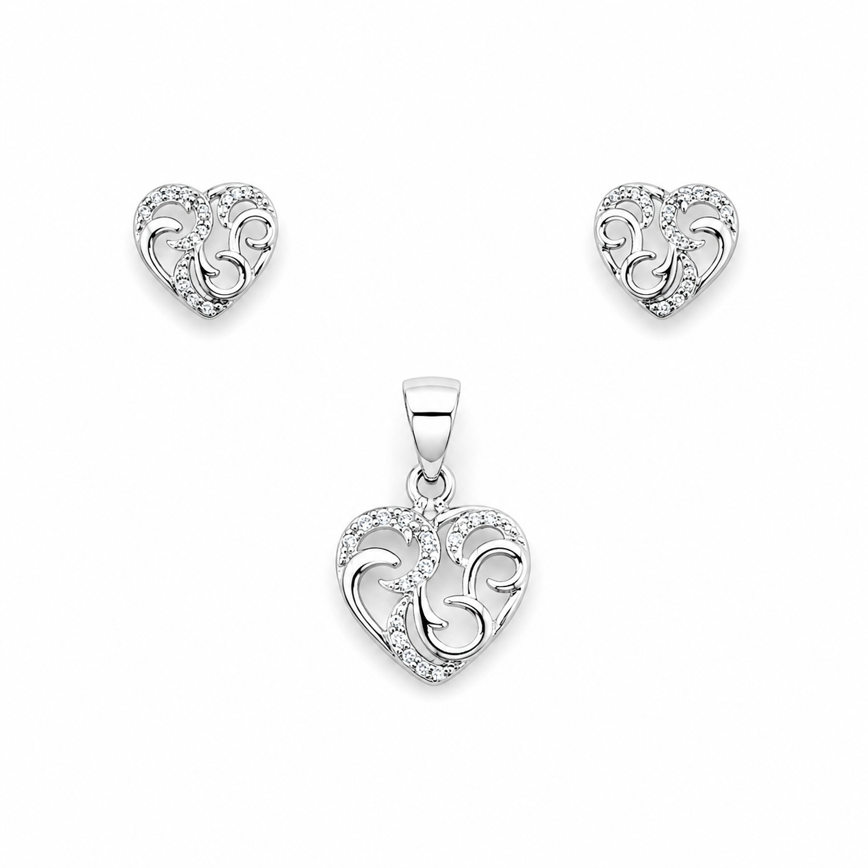 Silver filigree heart pendant and earring set on a white background
