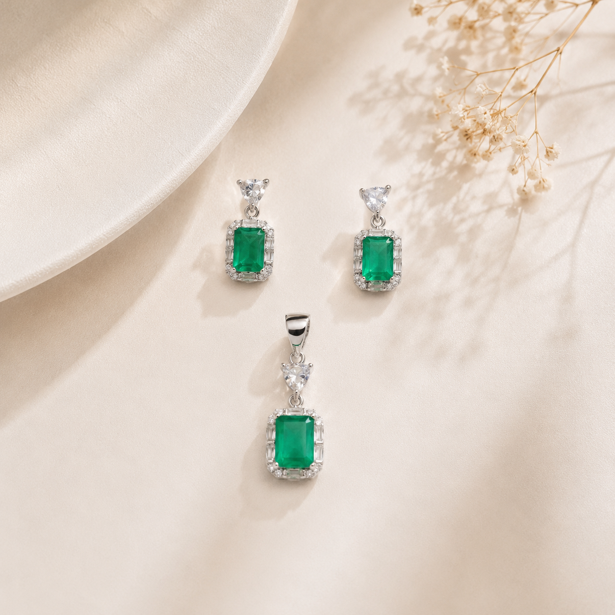 Close up of the emerald cut green stone pendant and earrings