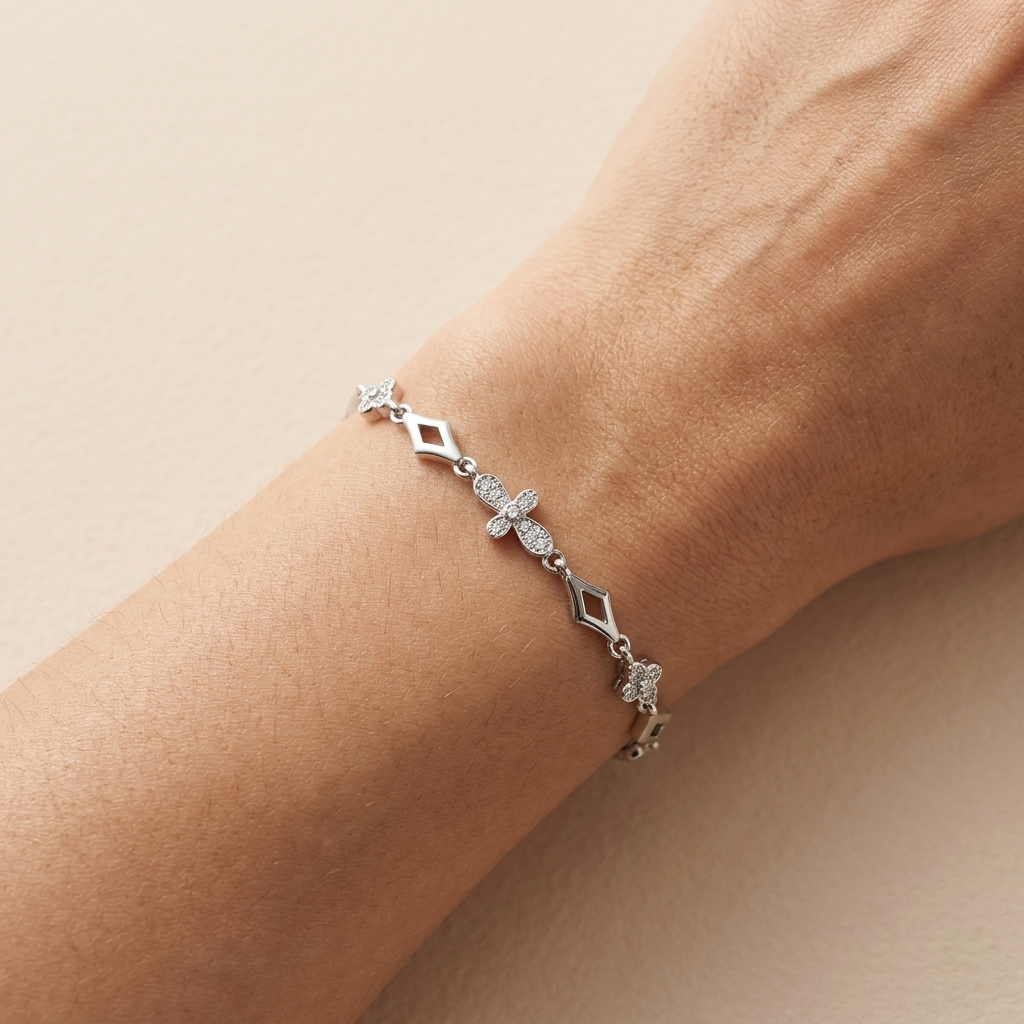 Close-up of a Floral Diamond Pattern Silver Bracelet featuring stone-studded floral and open rhombus links worn on a woman's wrist