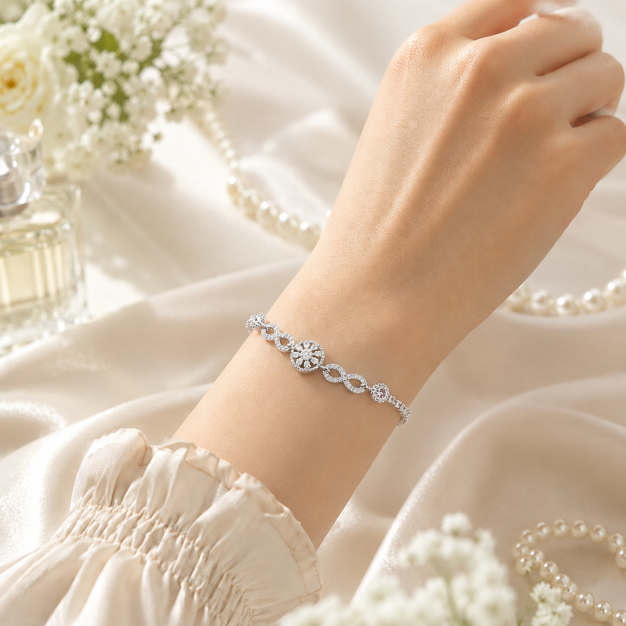 Close-up of the silver infinity links and lobster claw clasp on the crystal-studded bracelet