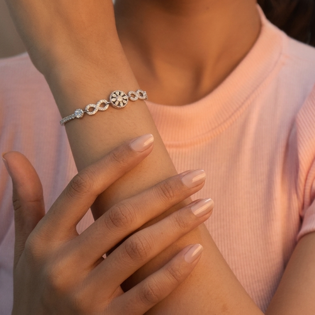 Full length view of the unclasped sterling silver infinity bracelet lying flat on a white surface