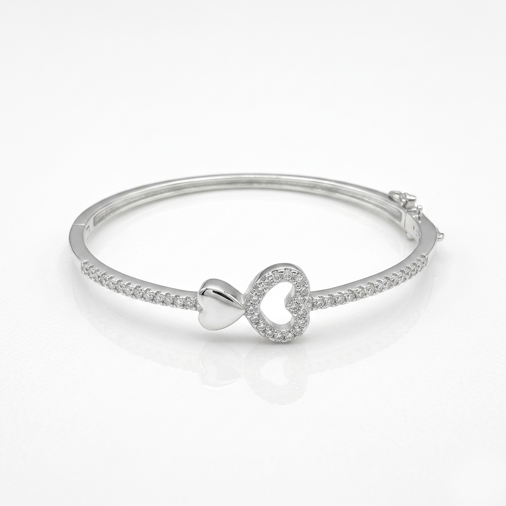 Close-up of the Heart Design Silver Bracelet on a white background, highlighting the micro-pave stone setting and side hinge mechanism. 