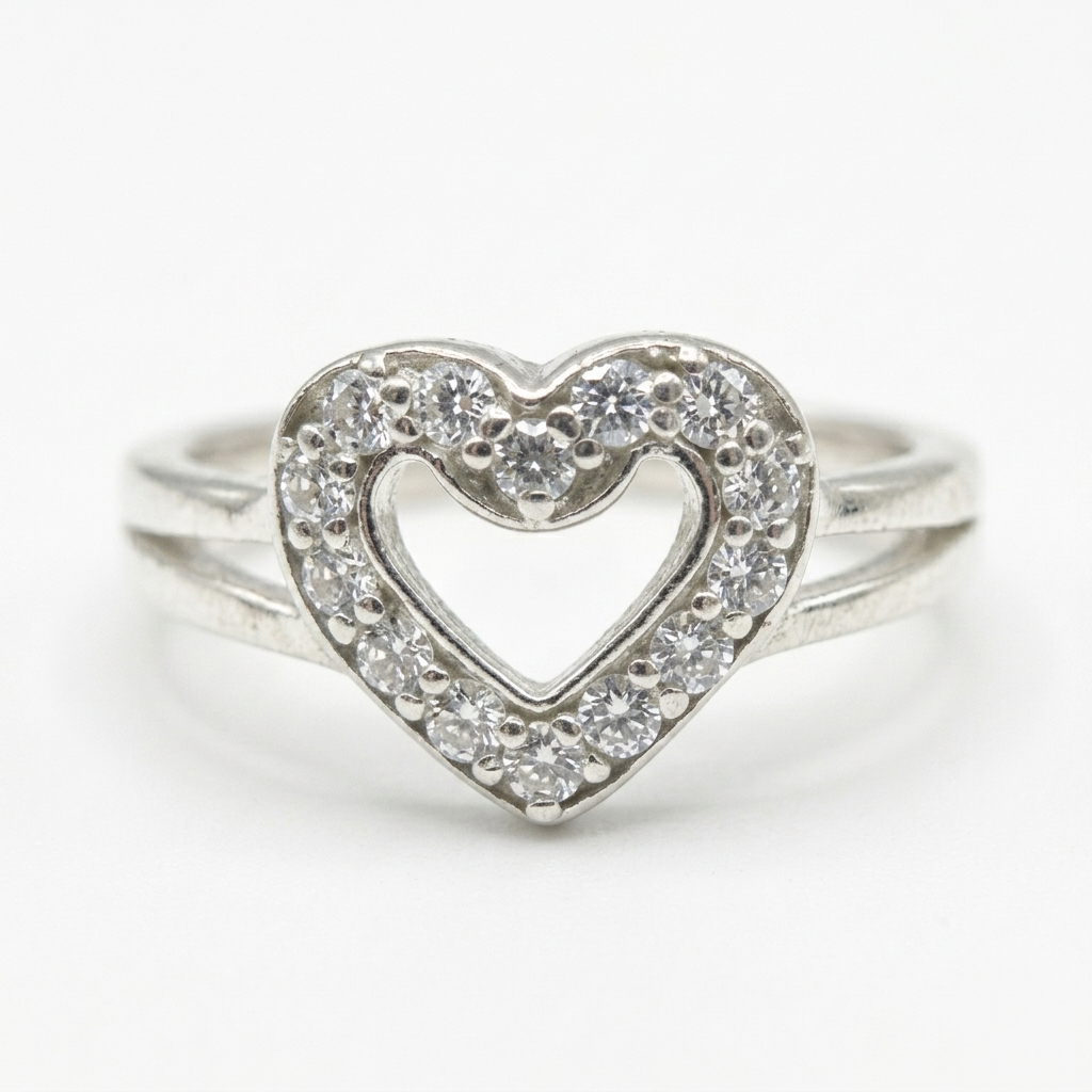 Close-up front view of a Heart Shape Silver Ring with a clear stone encrusted heart motif and split shank band.