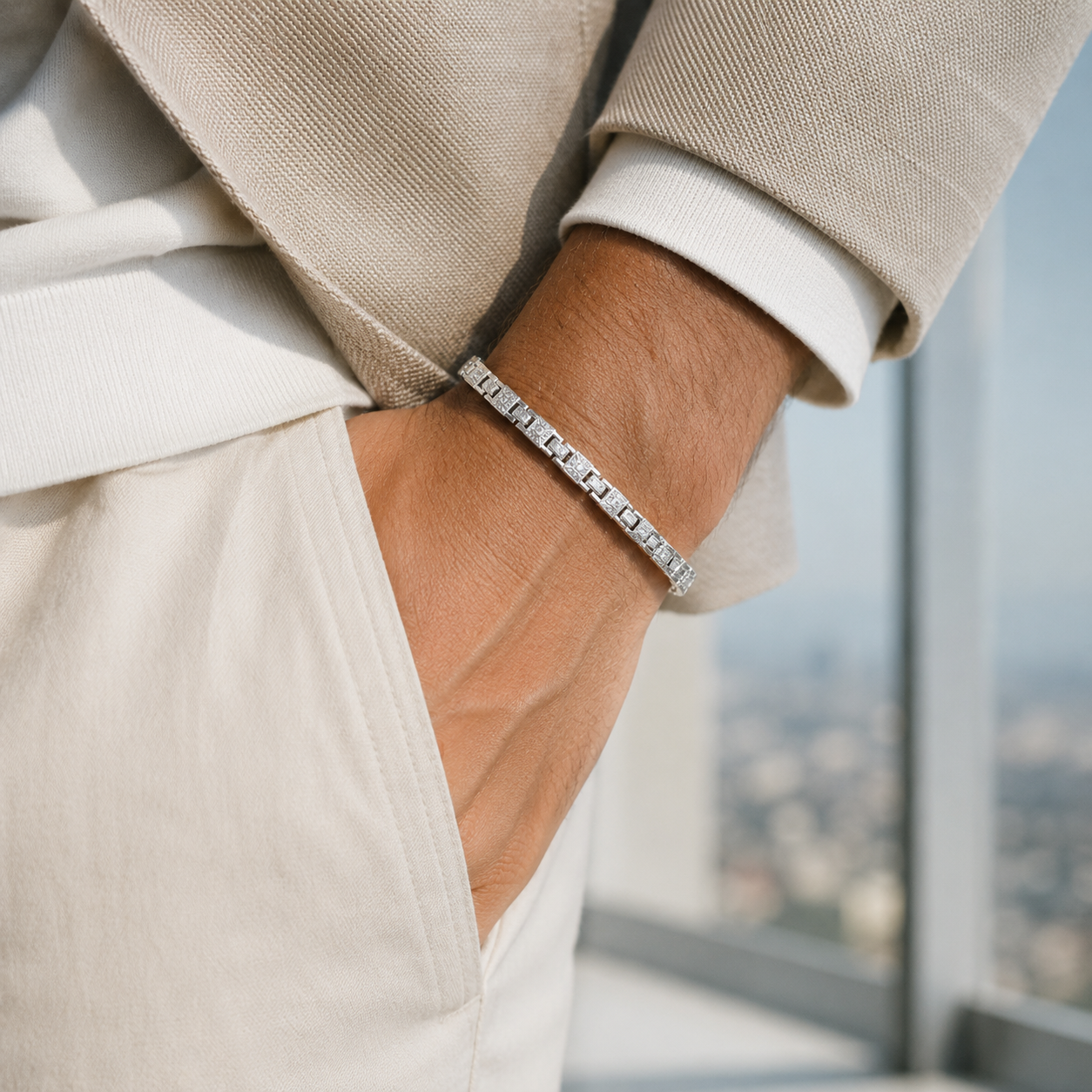 Top-down view of silver men's bracelet with rectangular textured links and lobster clasp