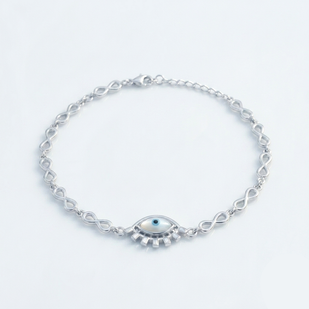 Silver bracelet featuring an infinity link chain and a central evil eye charm laying flat