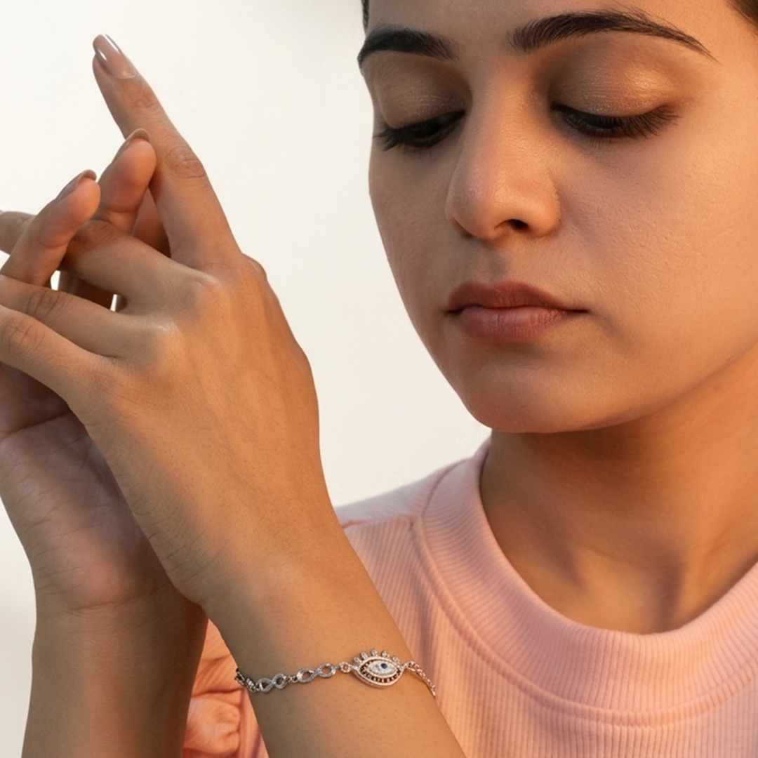 Delicate infinity link evil eye protection bracelet displayed on a bright white background
