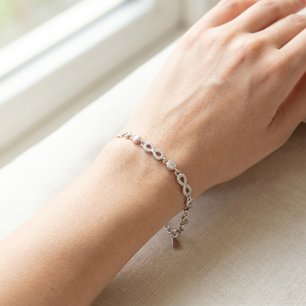 Close-up of the adjustable silver bracelet showing the lobster clasp and sparkling cubic zirconia stones.