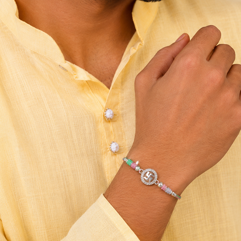 Sacred Swastik Silver Rakhi with Pastel Beads