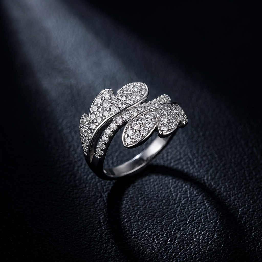 Sparkling Leaf design Silver Ring highlighted by a dramatic spotlight against a dark textured background