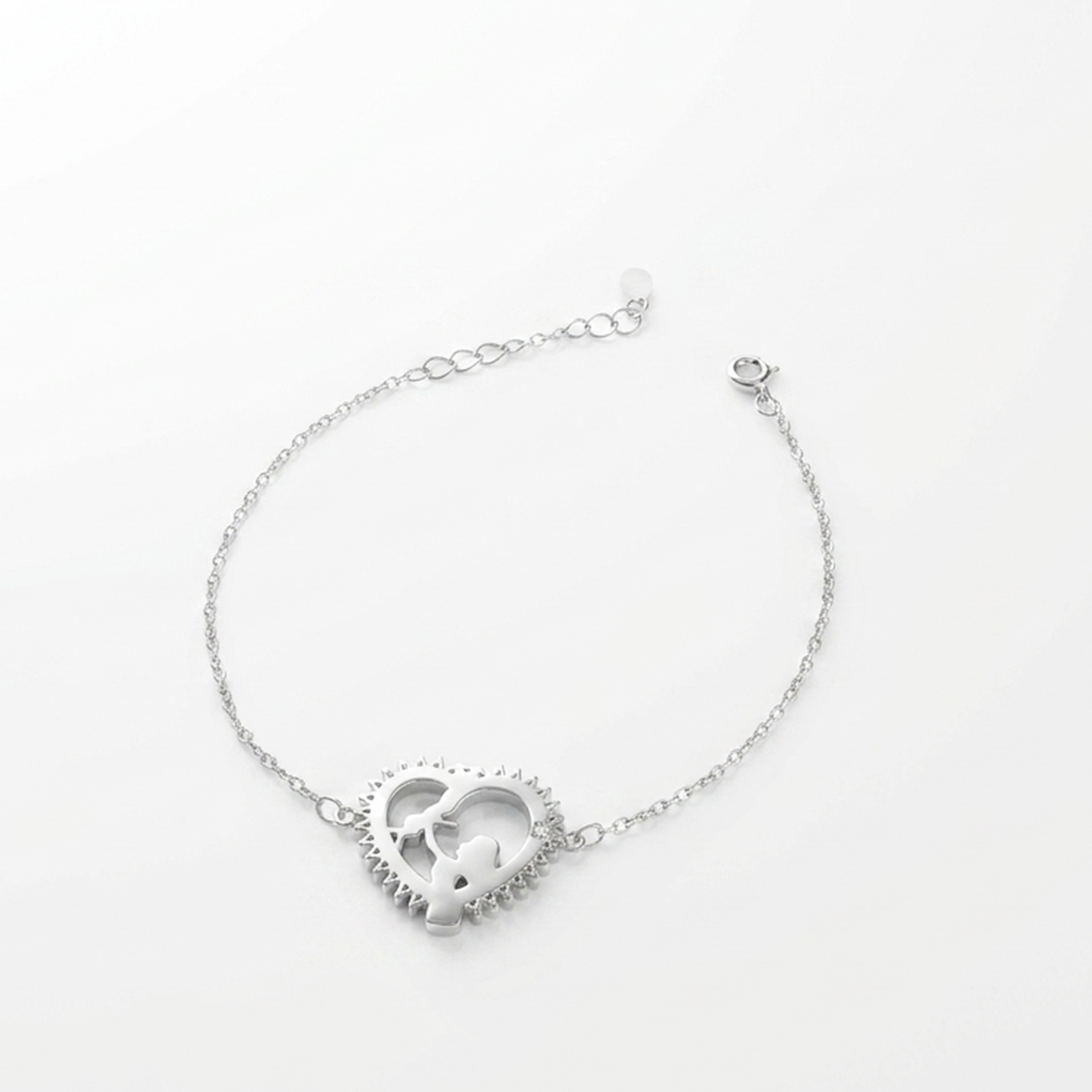 Silver bracelet featuring an open heart charm with a mother and child silhouette