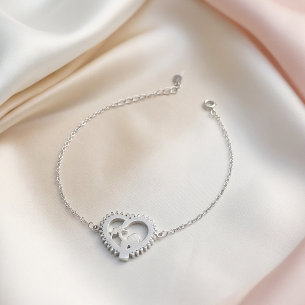 Top down view of the mother and child heart bracelet resting on a plain white background