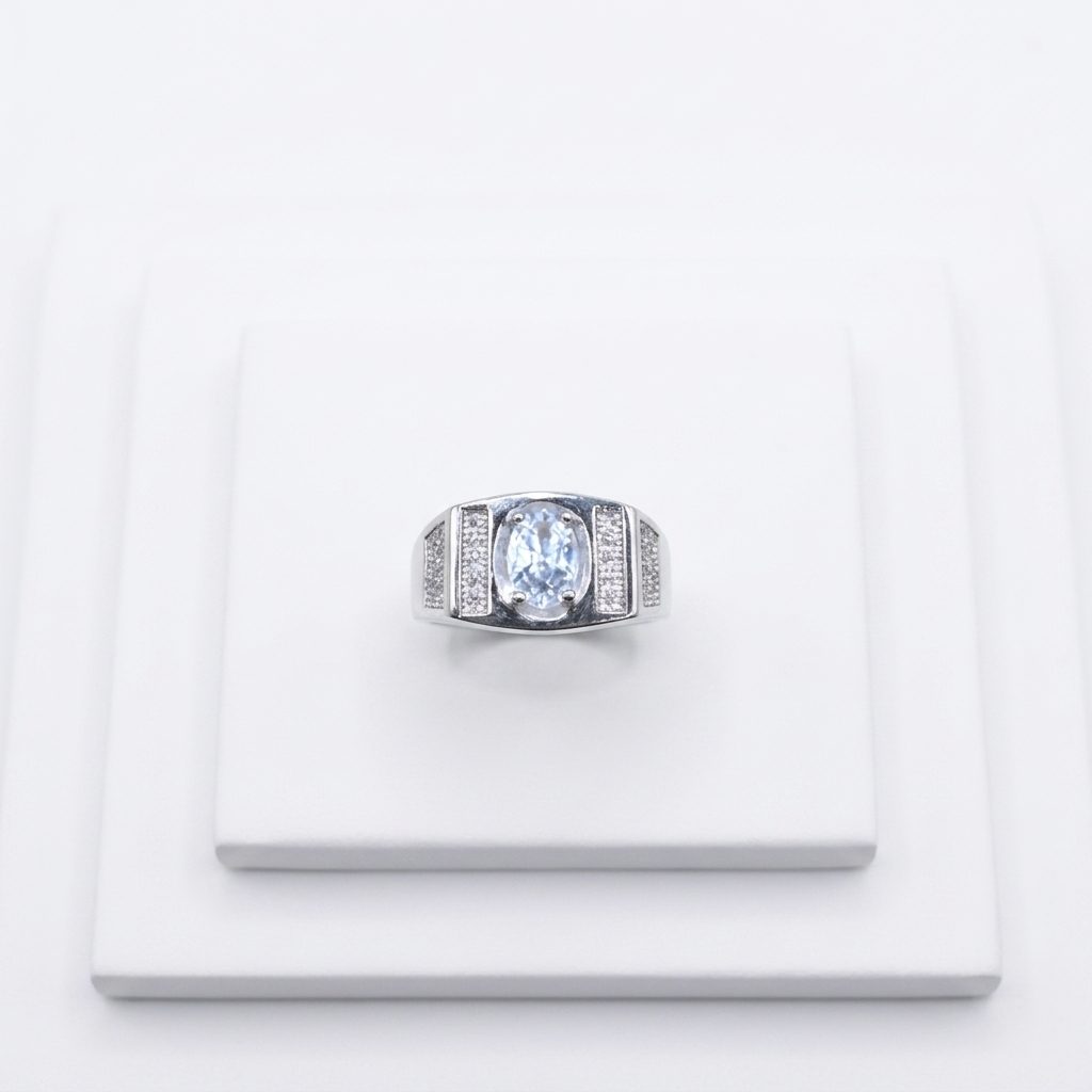 Frontal close-up of the Oval Diamond Silver Ring displayed on a clean white tiered pedestal.