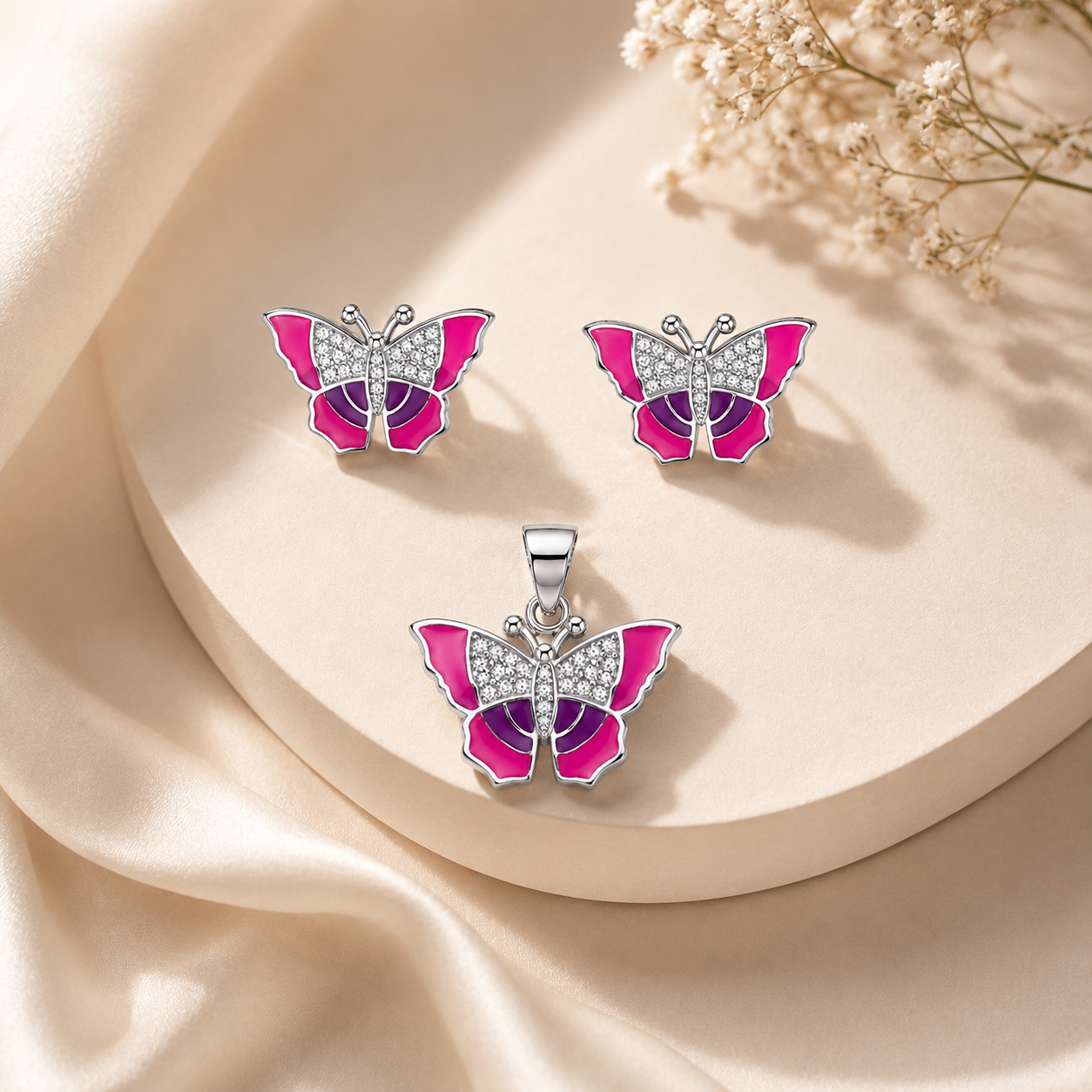 Close-up of silver butterfly earrings showing deep purple and pink enamel on the lower wings.