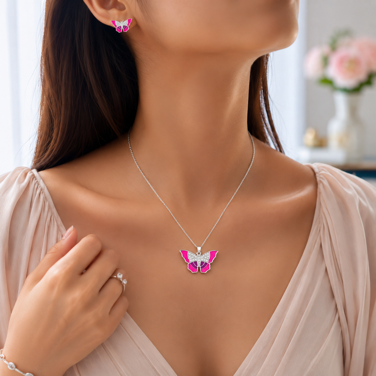 Silver butterfly pendant showcasing vibrant hot pink borders and crystal-studded upper inner wings.