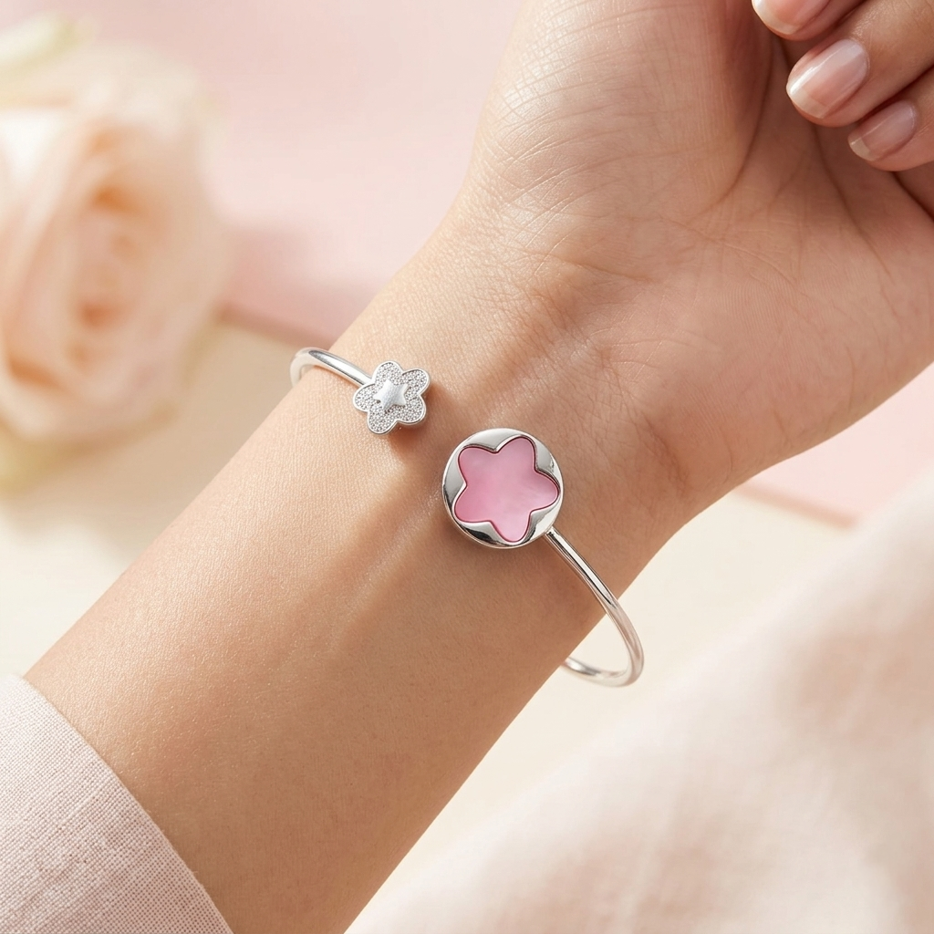 Close-up of a Pink Flower Open Kada featuring a pink enamel flower and a crystal-studded charm on a woman's wrist