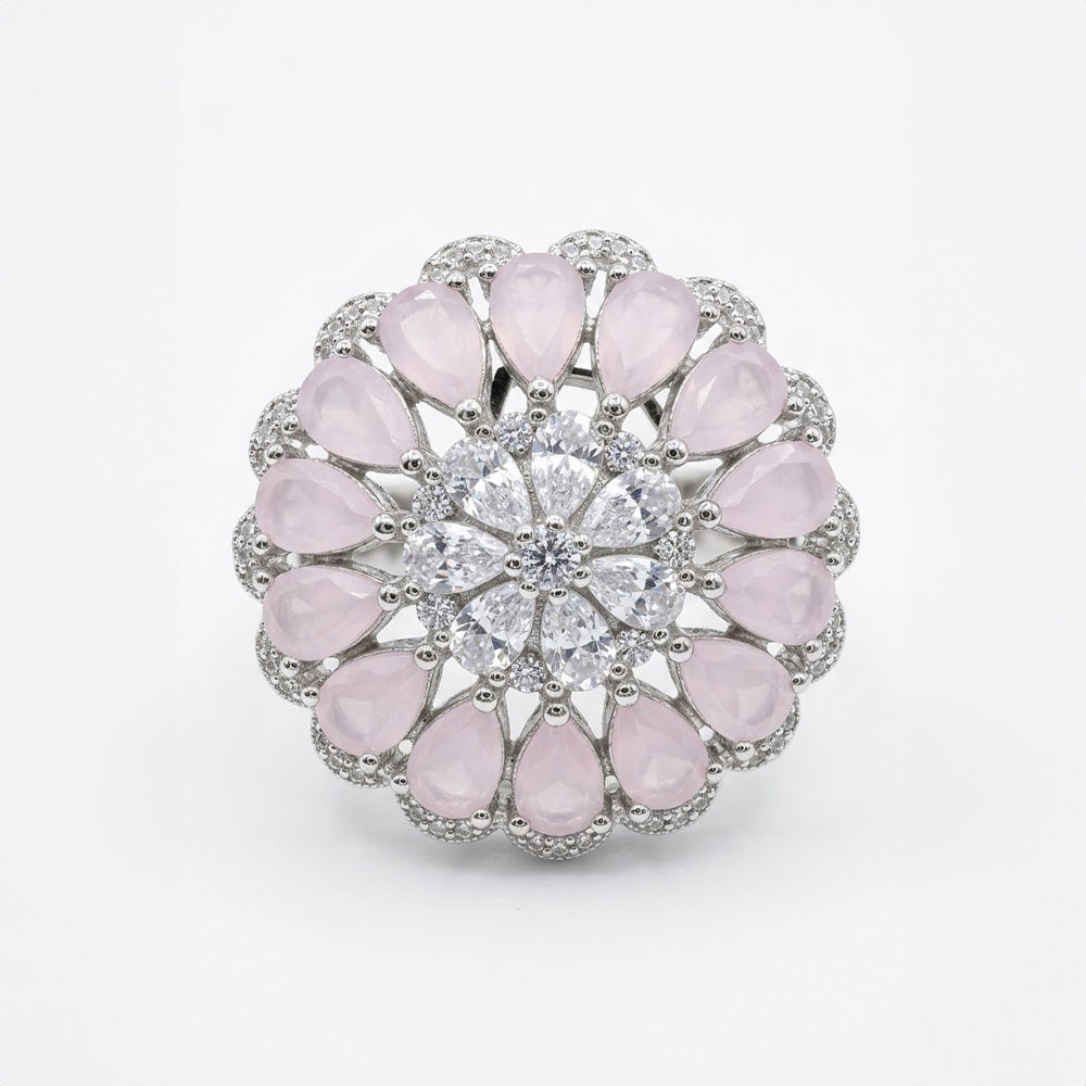 Close-up detail of a mandala design sterling silver ring with pink stone halo and sparkling clear center crystals.