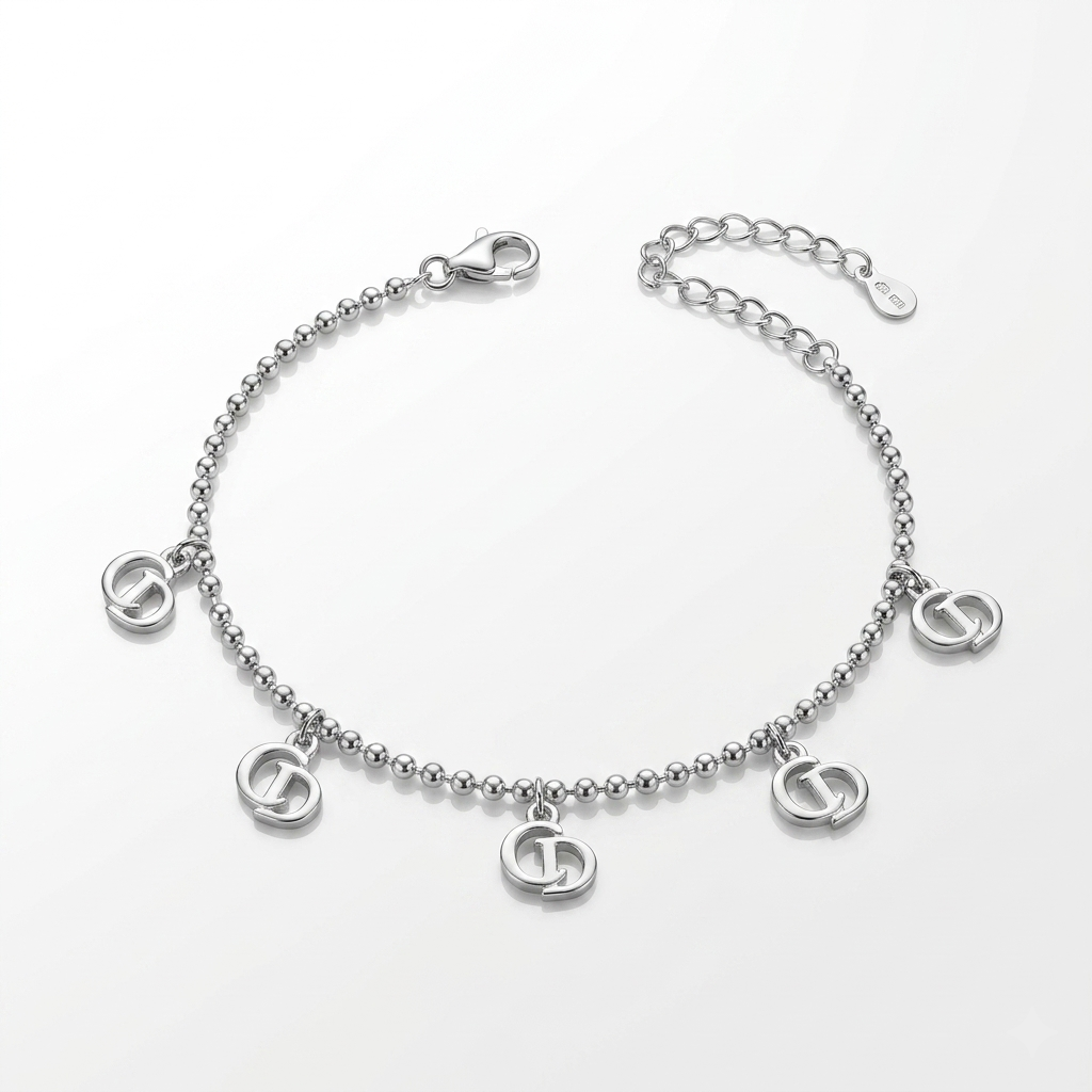 Silver ball chain bracelet laid flat showing five interlocking circle charms