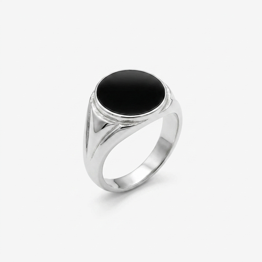 Detailed studio shot of the Silver Black Stone Signet Ring on a white background, highlighting the smooth round black stone and grooved band accents.