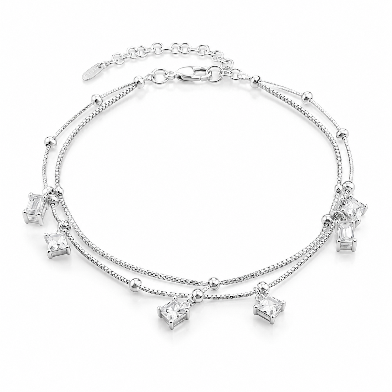 Silver double layer box chain anklet with dangling square clear crystals on a white background