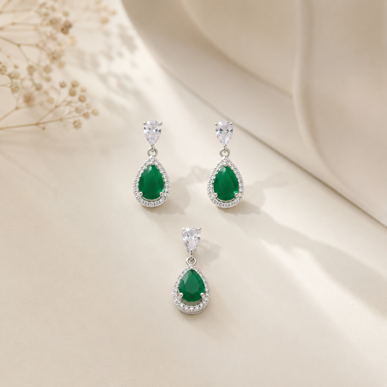 Close-up of the emerald green teardrop necklace and matching earrings
