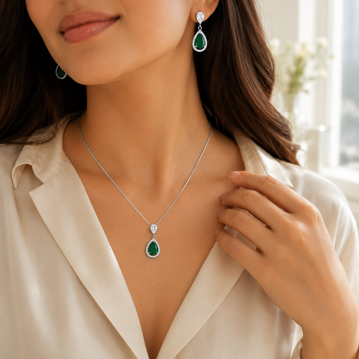 Pear-shaped green stone jewelry set featuring sparkling clear halos