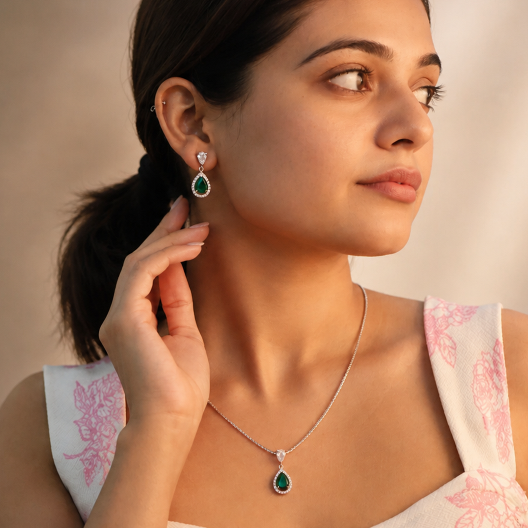 Silver-tone delicate chain necklace and drop earrings with vivid green center stones