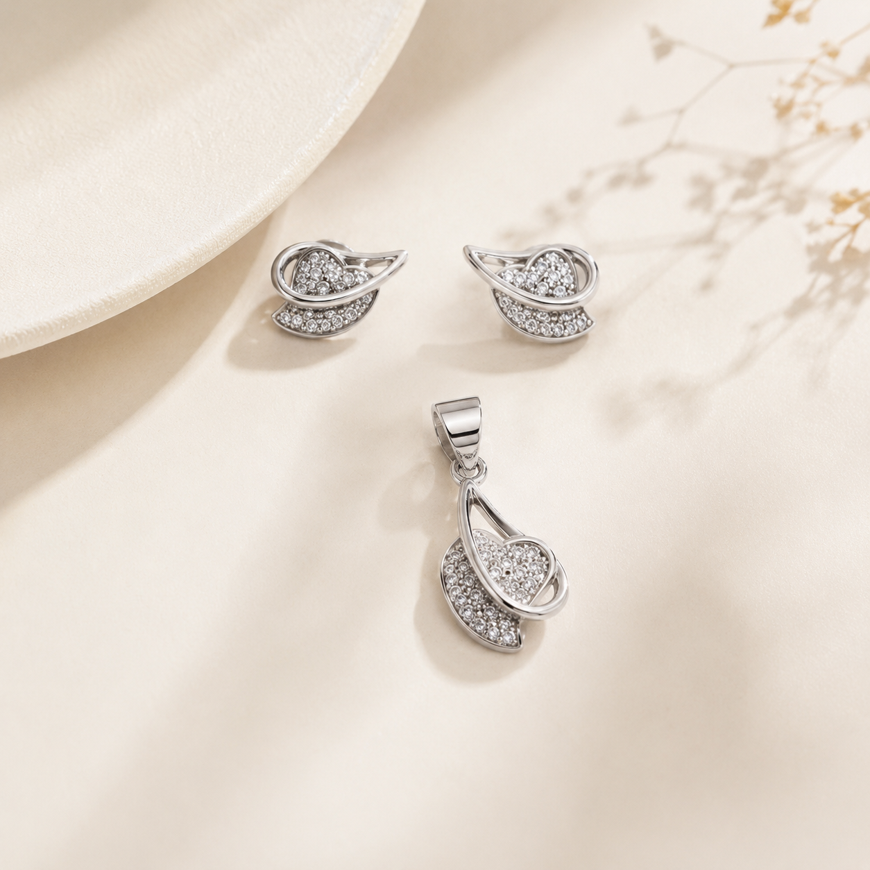 Delicate silver plated jewelry set with abstract heart and leaf shapes and clear stones