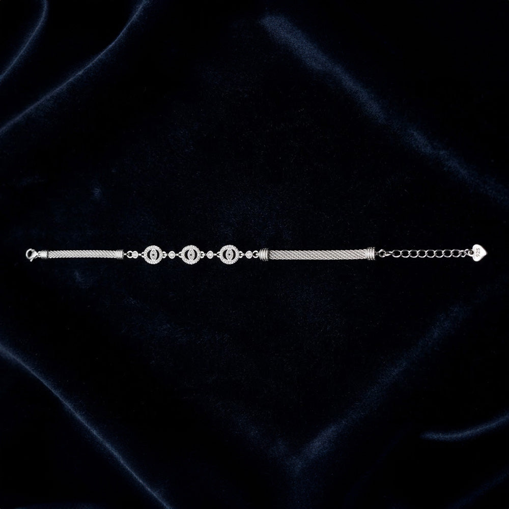 Flat-lay of the Silver Flower Charm Bracelet on a black background