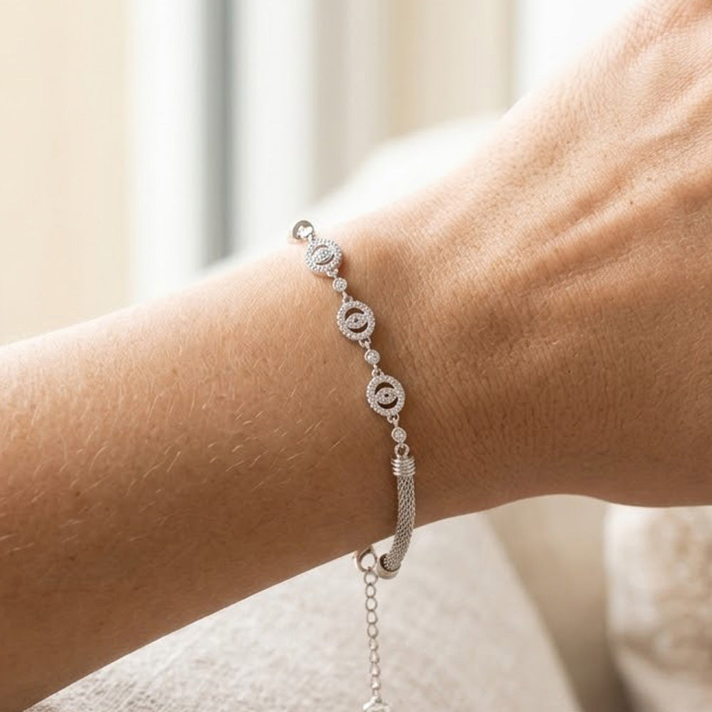 Close-up of the Silver Flower Charm Bracelet worn on a wrist