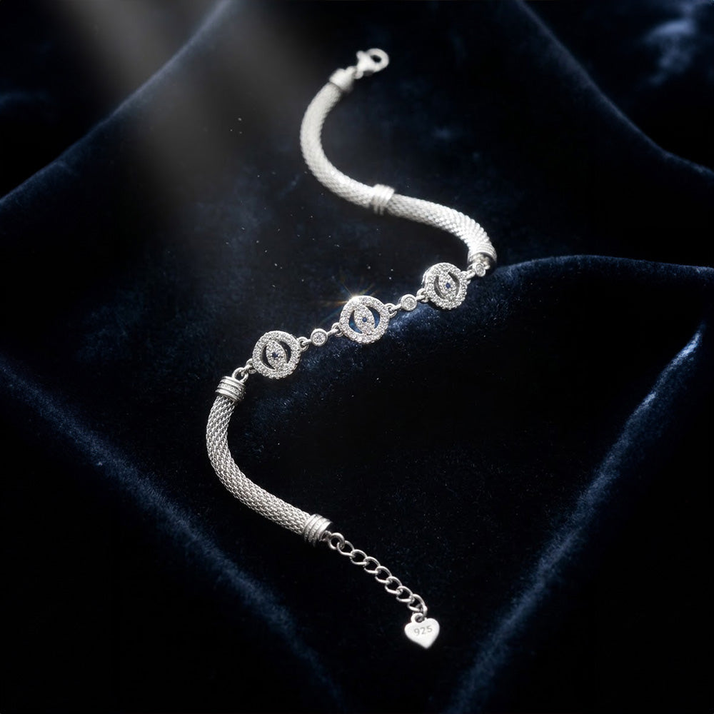 Silver Flower Charm Bracelet showing its "925" heart tag on blue velvet