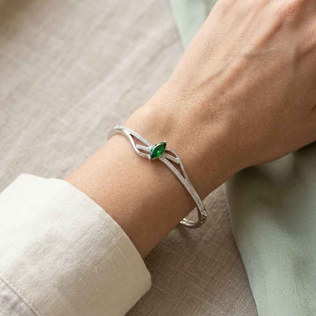  Close-up of a Silver Green Stone Kada for Women with a marquise green stone worn on a woman's wrist