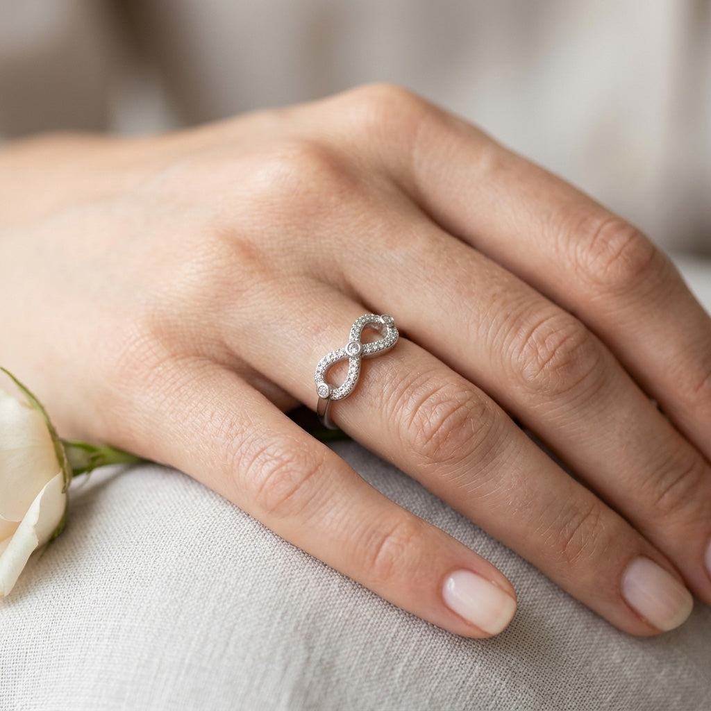 A woman wearing the 925 Silver Crystal Infinity Ring on her finger, highlighting its slim profile and elegant sparkle for everyday wear.