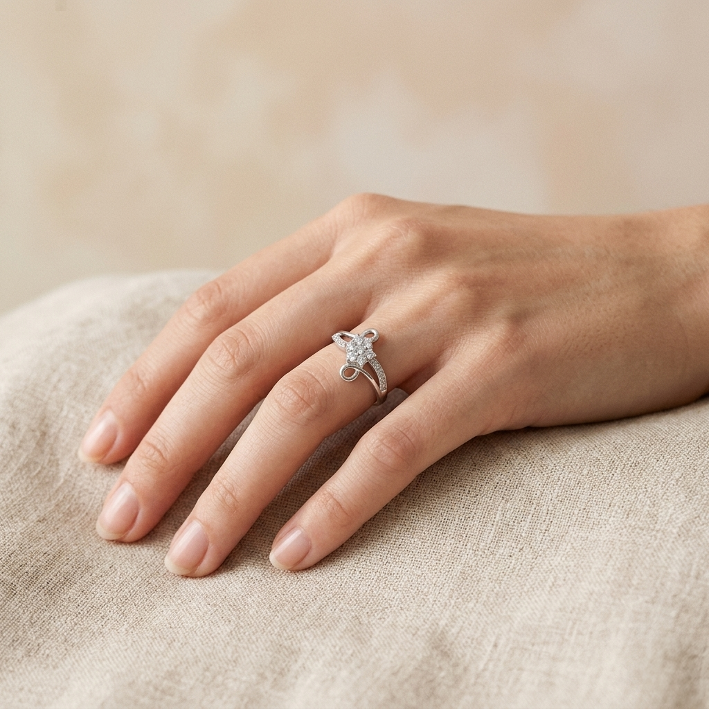 Woman's hand resting on light linen fabric wearing the Silver Infinity Swirl Crystal ring.