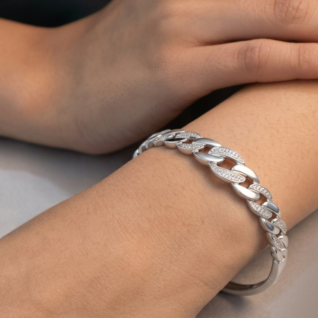 Close-up detail of the smooth and pave silver links on the stiff bracelet