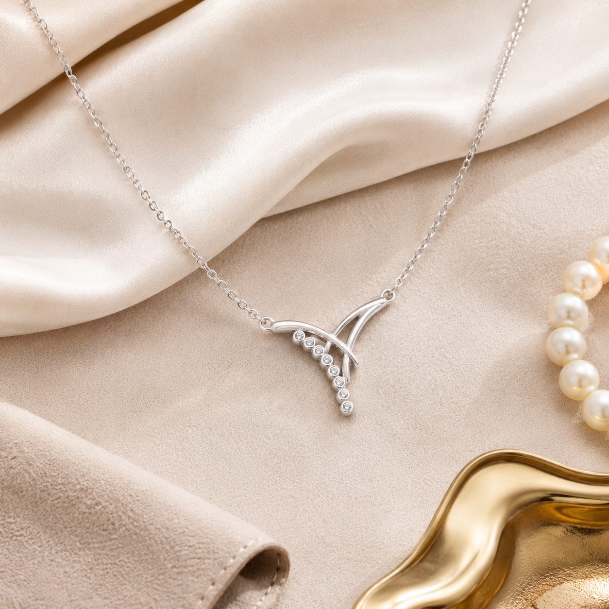 Close up of the asymmetrical silver curves and sparkling stones on the geometric necklace