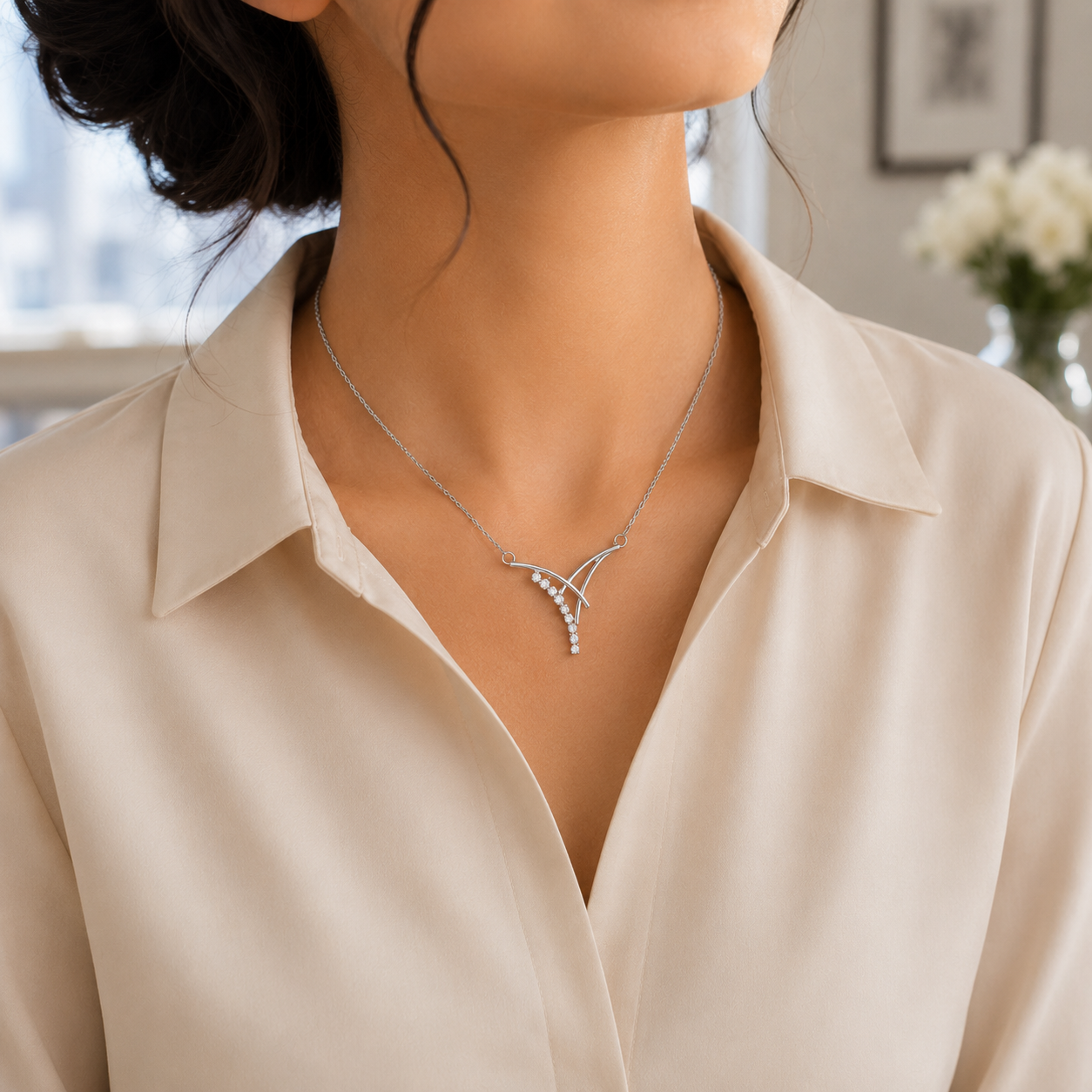 Frontal view of the sterling silver V-shape drop pendant and attached cable chain