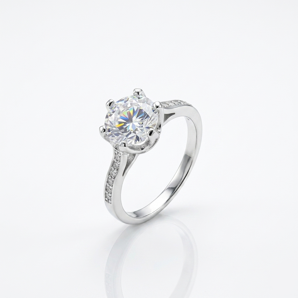  Macro shot of a brilliant round-cut Solitaire Ring for Women featuring a six-prong crown setting and pavé shoulders on a white background.
