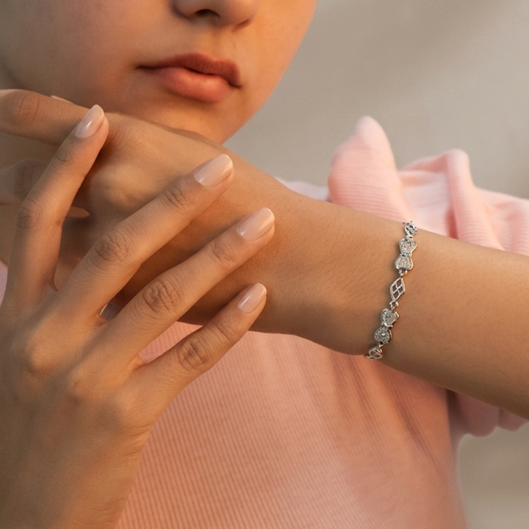 Full view of the elegant sparkling bow-link bracelet with lobster clasp.