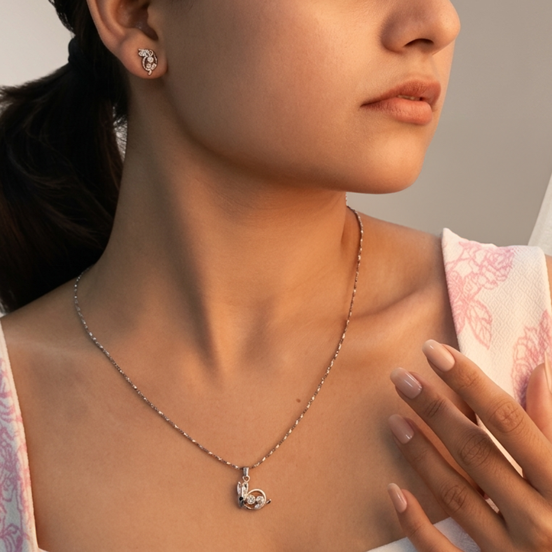 Top view of the cut-out rabbit silhouette earrings and pendant with contrasting black eye gems.