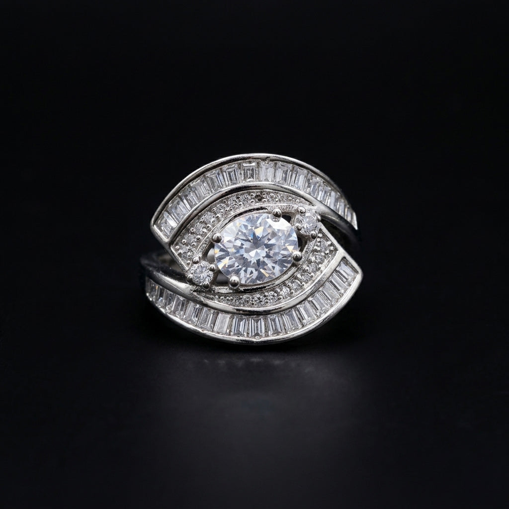 Detailed front-facing view of the Swirl Diamond Silver Ring on a solid black background, emphasizing the intricate channel-set baguette stones, pavé accents, and large round center stone