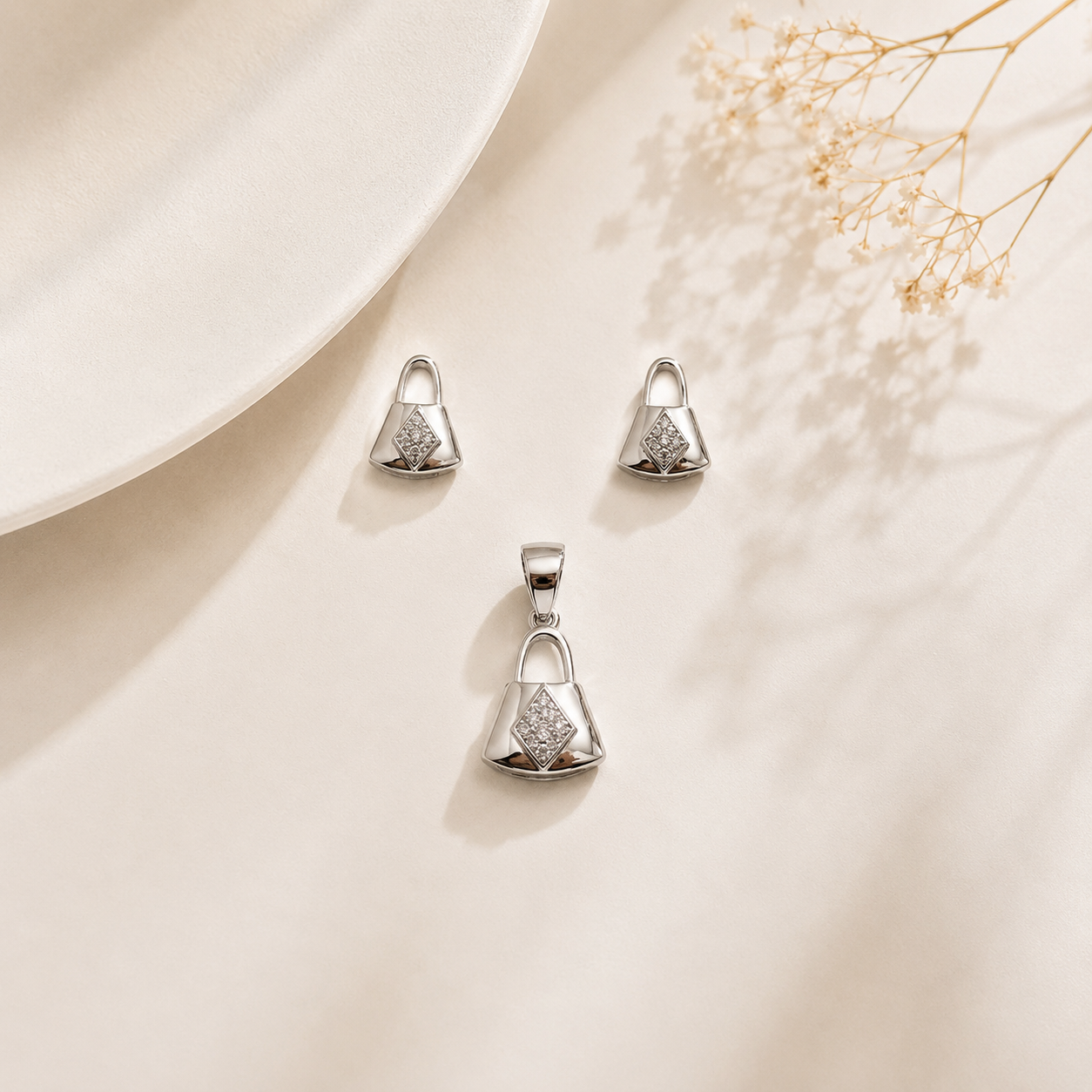 Close-up of the miniature handbag design and diamond-shaped CZ cluster on the sterling silver jewelry set