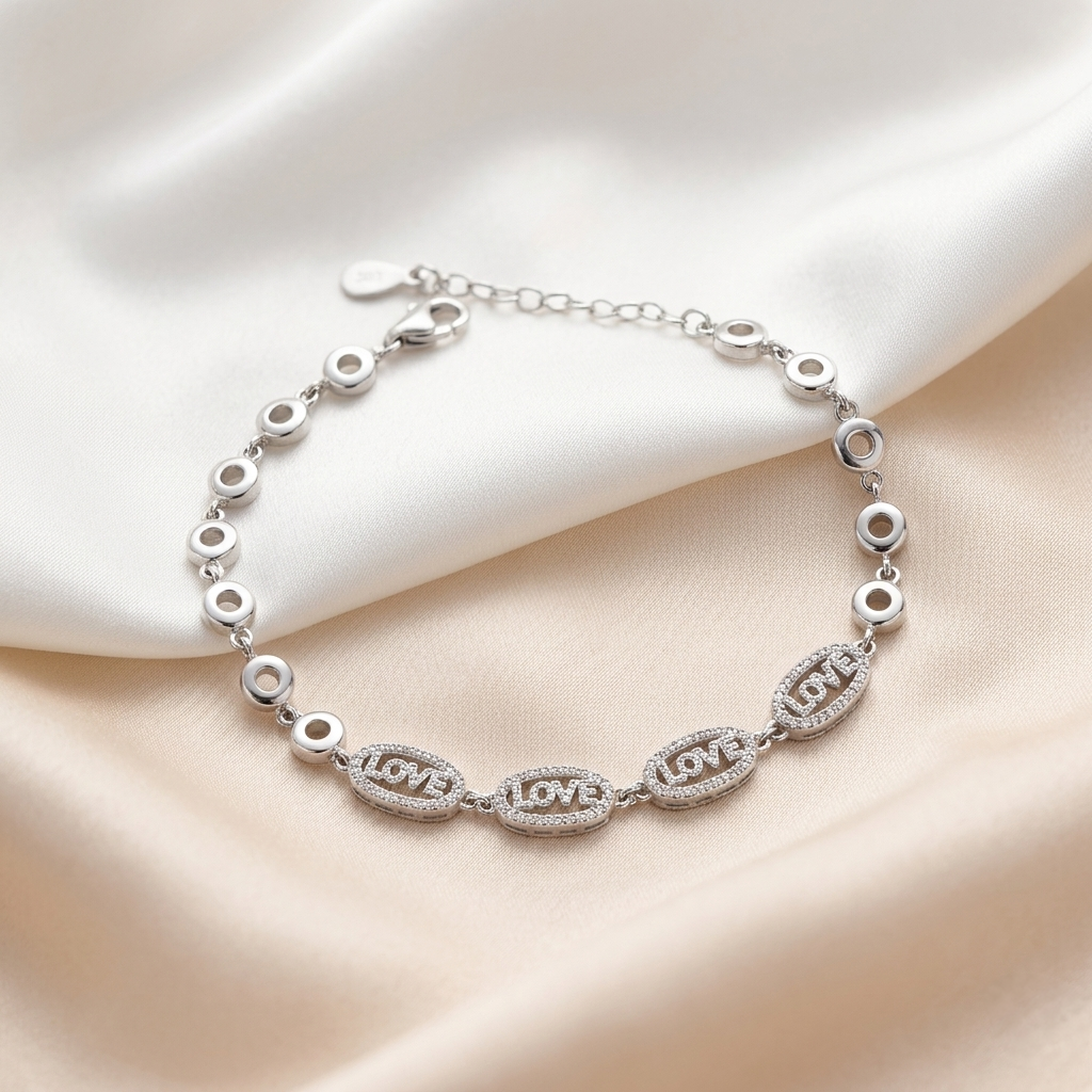 Close-up of the lobster clasp and adjustable extension chain on the silver love bracelet.
