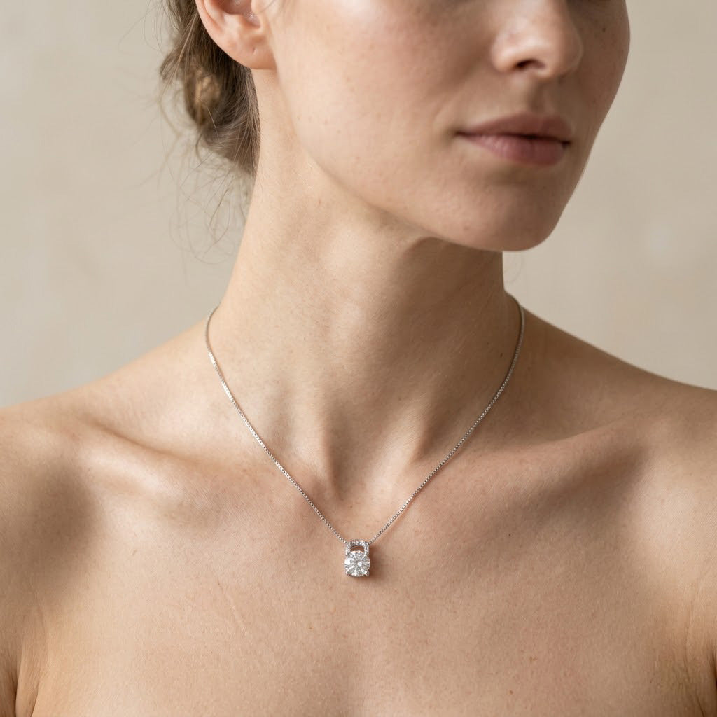 Close-up of the delicate Sterling Silver Round Solitaire Pendant Necklace resting on a woman's collarbone