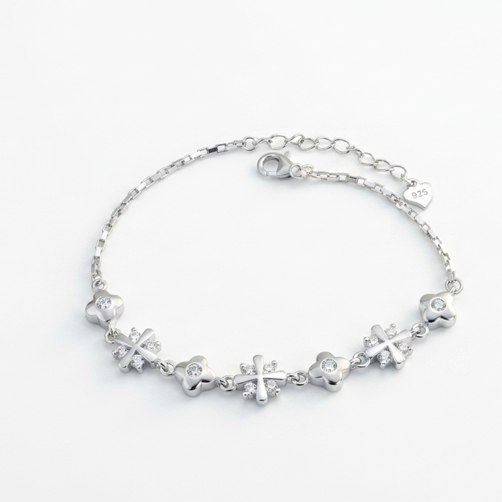 Sterling silver bracelet with sparkling floral star motifs laid flat on a white background